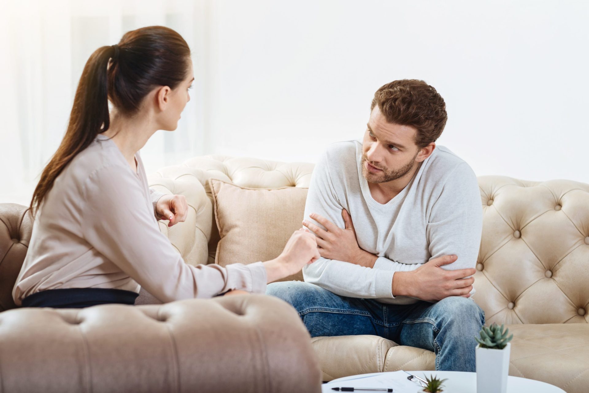 Nice,Pleasant,Couple,Talking,To,Each,Other two people talking sitting on a couch