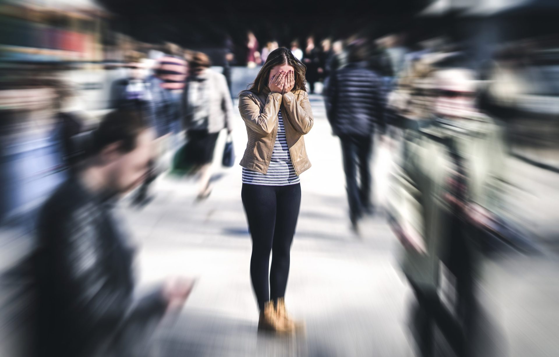 Panic attack in public place. Woman having panic disorder in city. Psychology, solitude, fear or mental health problems concept. Depressed sad person surrounded by people walking in busy street. Woman having anxiety in city.