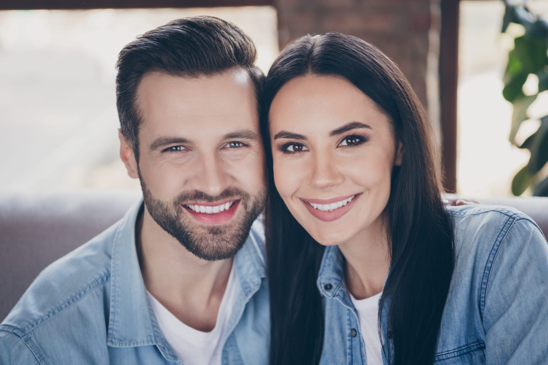 Close up photo of idyllic passionate loving family woman man enjoy spend quarantine together toothy smile wear denim jeans shirt in house room apartment indoors