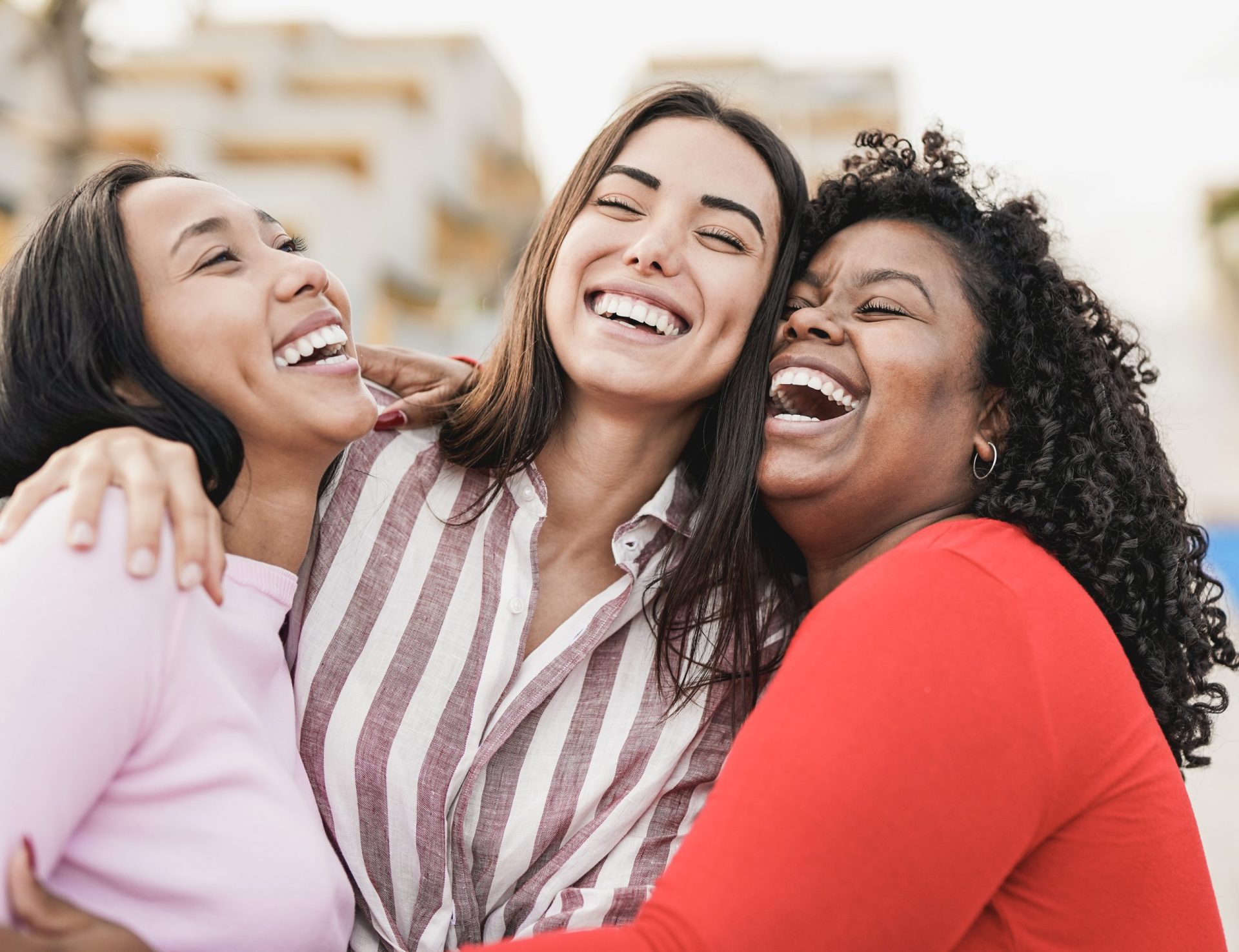 Three friends laughing together