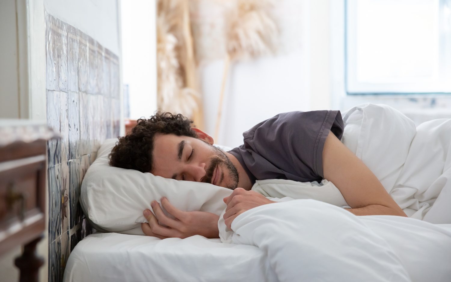 man peacefully sleeping in bed