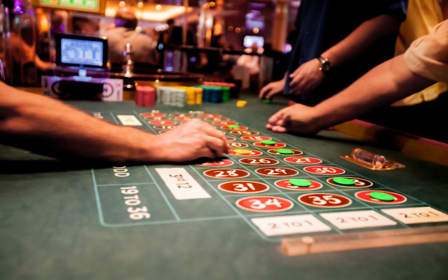 people sitting around a table gambling