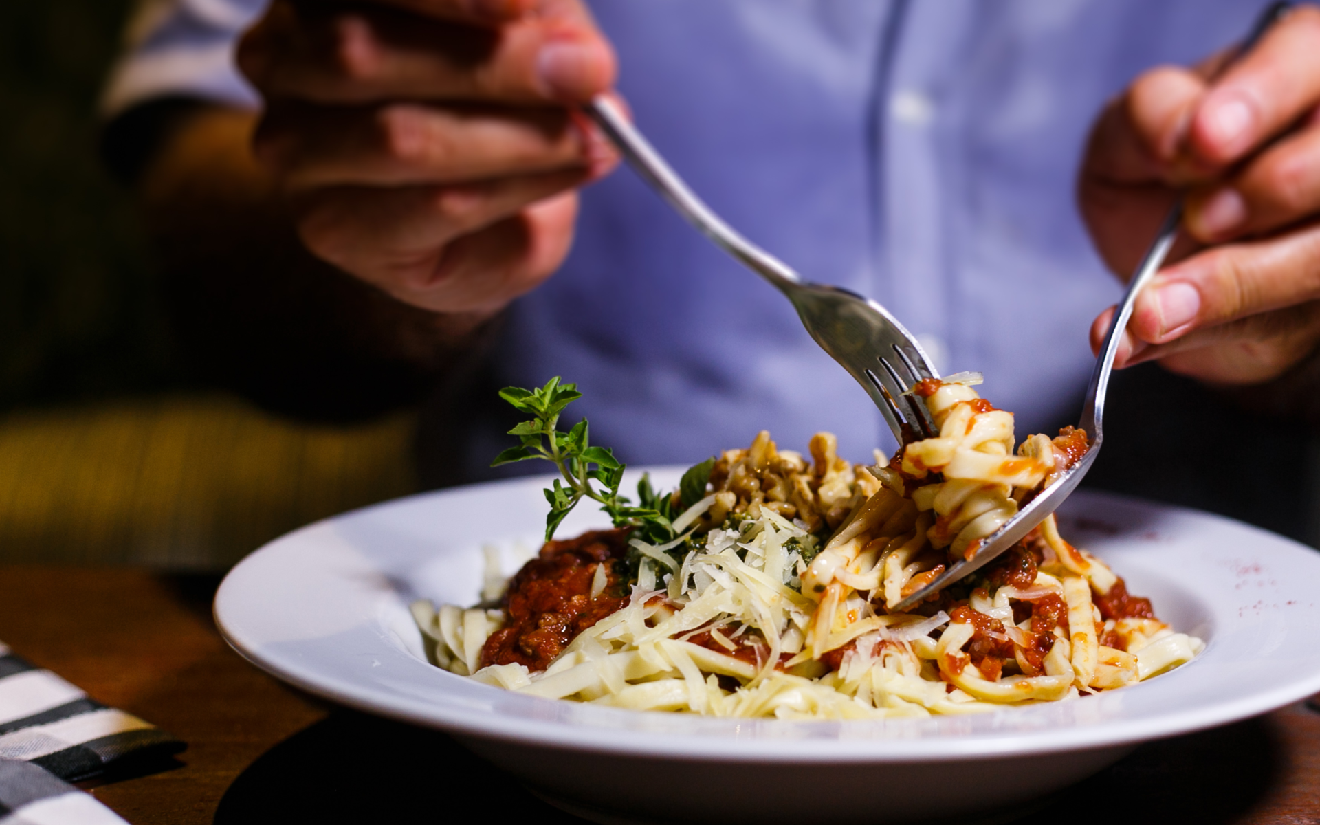 Close up image of person twirling spaghetti onto a fork