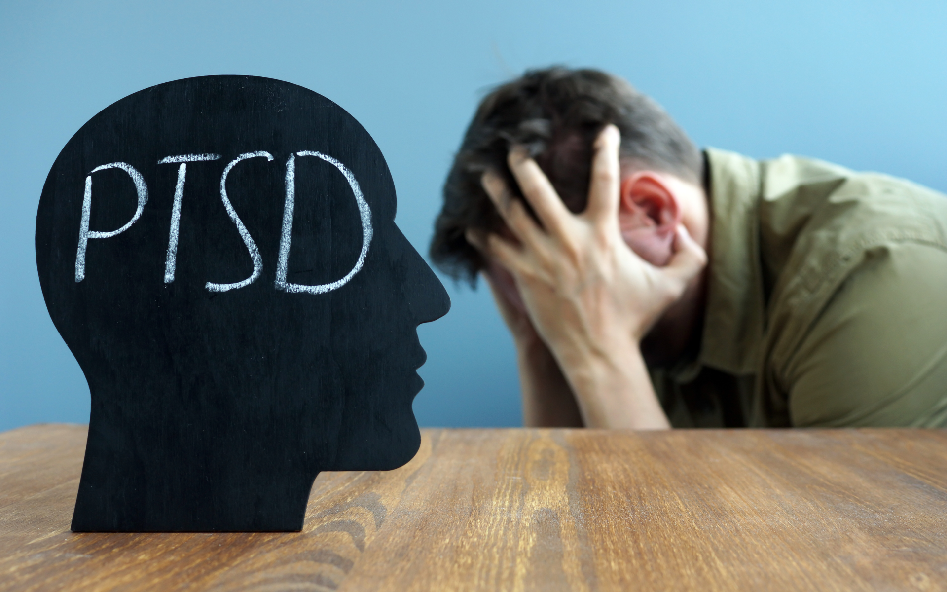 Silhouette of person's head that reads PTSD