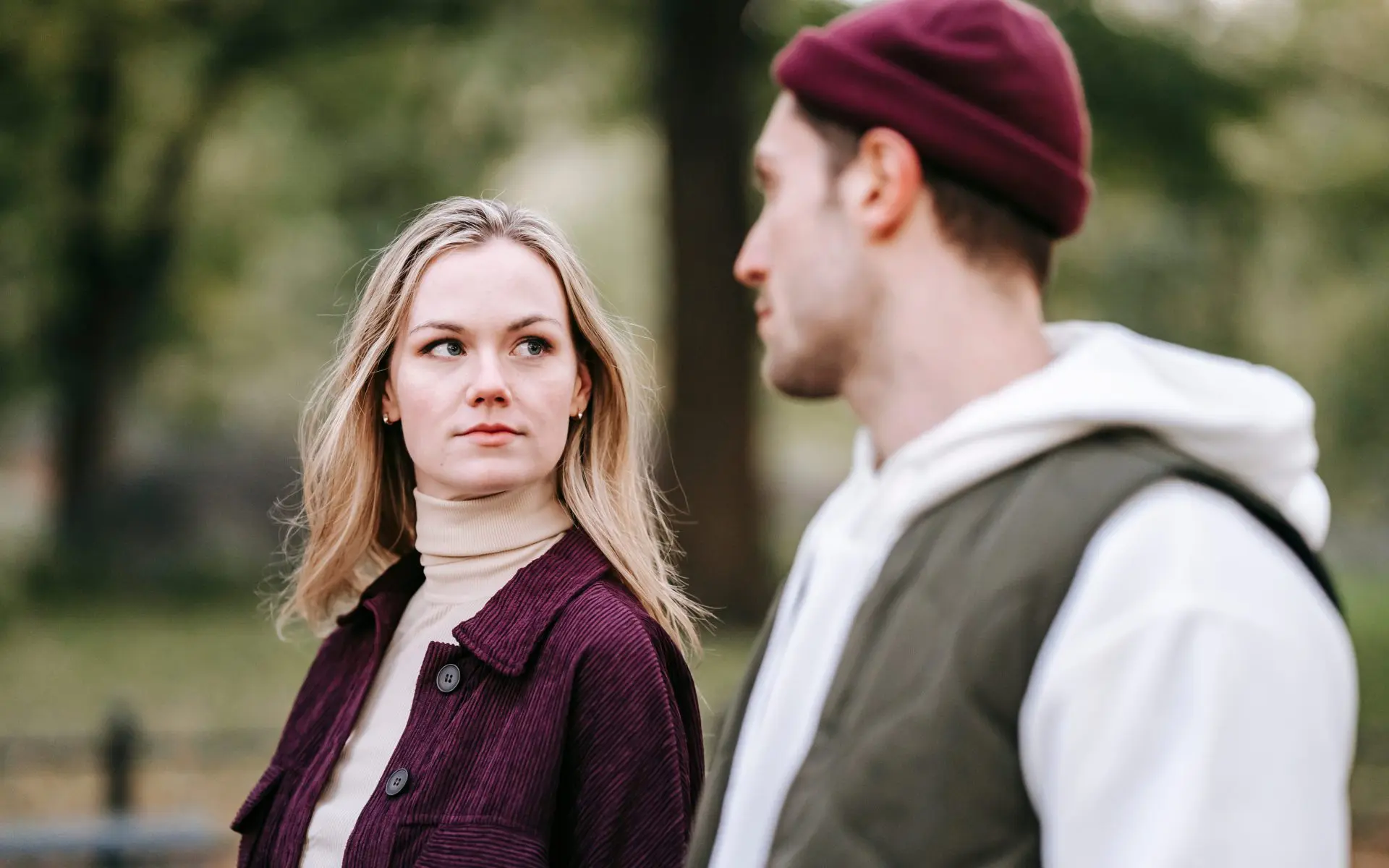 couple walking outside looking serious