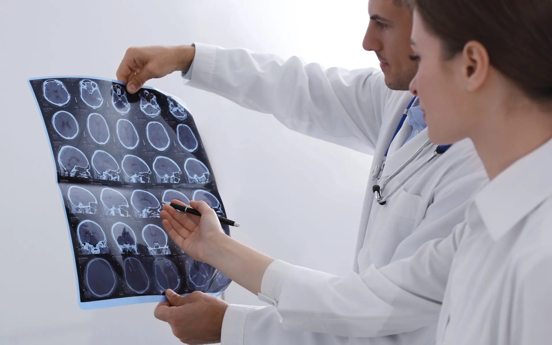 doctors reviewing images of brain scans