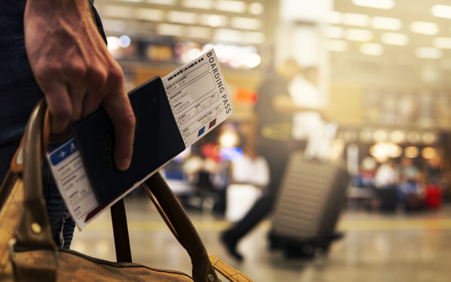 holding a boarding pass at the airport