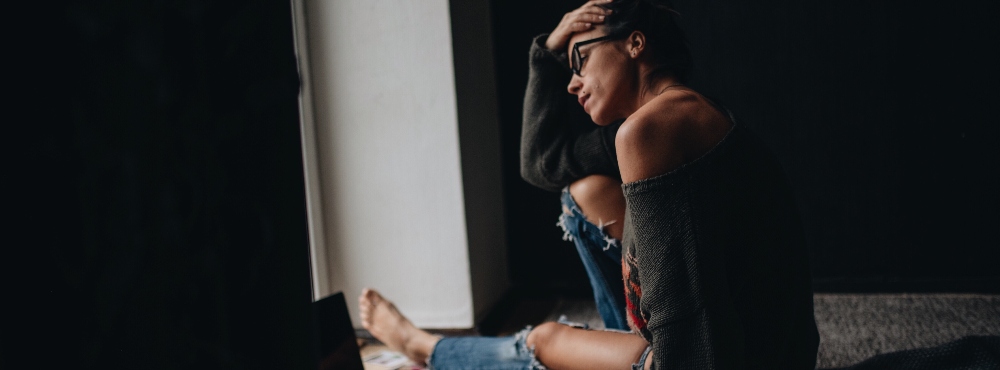 Depressed individual sitting on the floor