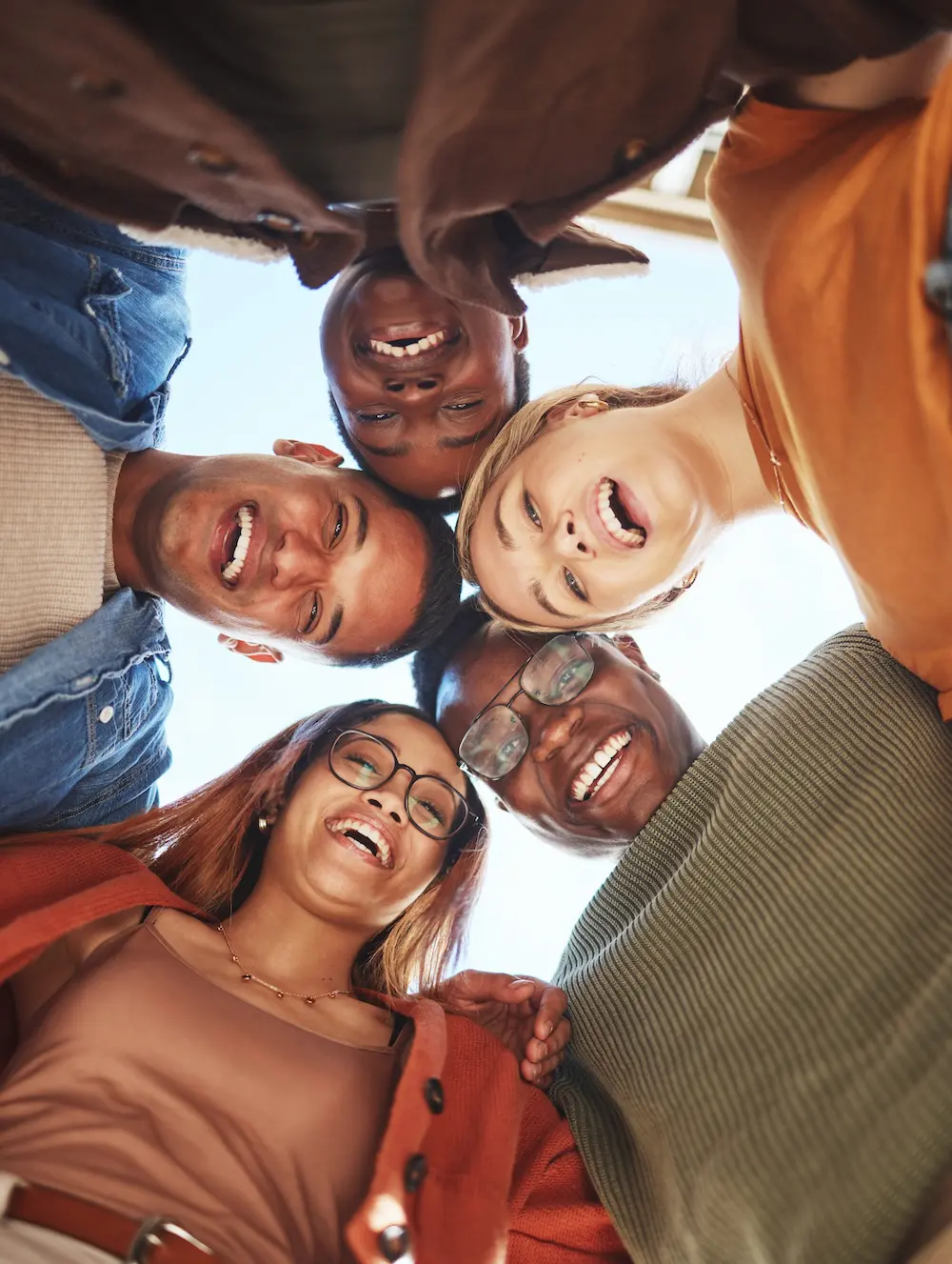 new dimensions day treatment centers suicidal ideation program: Group huddle smiling from below