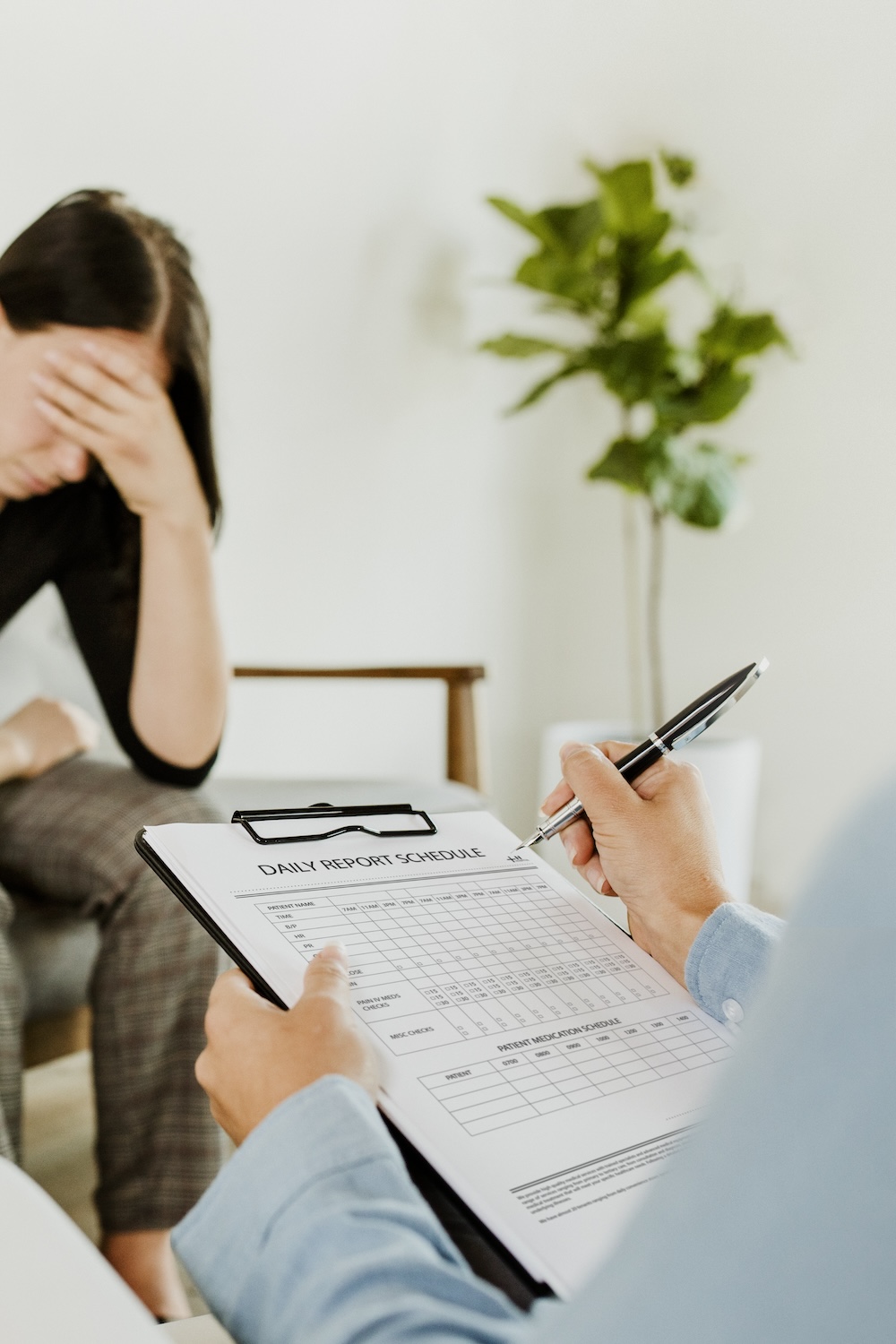 Psychiatrist taking notes to intake patient to PHP