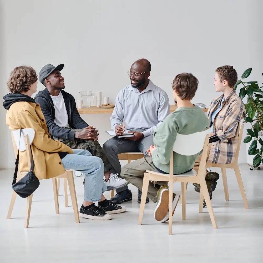 IOP for Addiction in Houston - New Dimensions Day Treatment Centers Substance Abuse Program Group of clients sitting with therapist