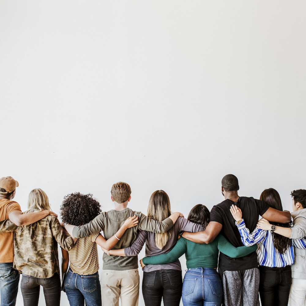 Rearview of diverse people hugging each other